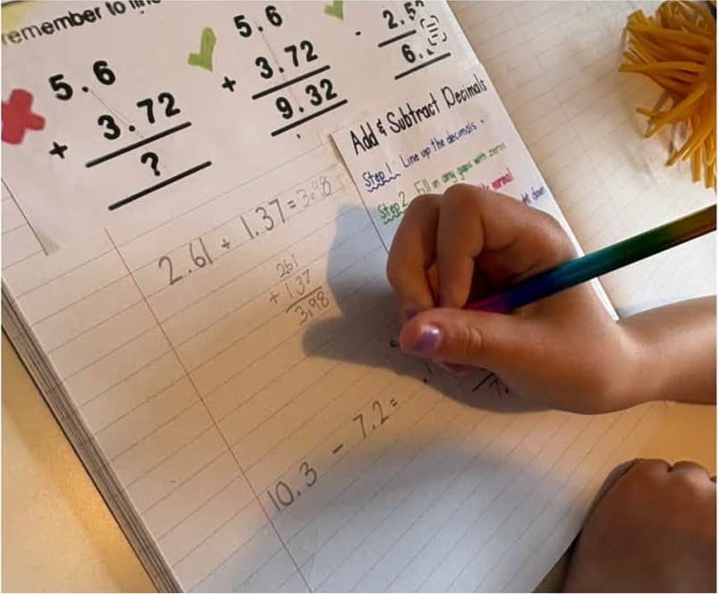 Adding decimals in a maths workbook