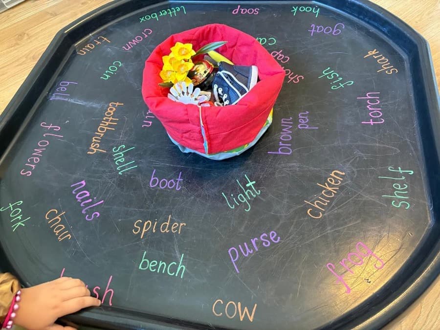 A word and object matching game on a tuff tray