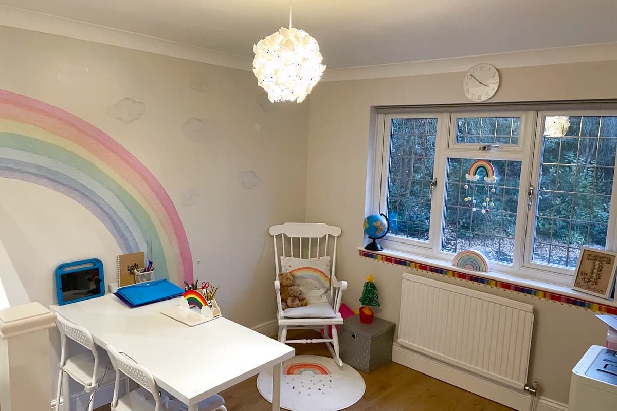 A bright learning room with a rainbow wall